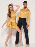 Two young adult dancers wearing western-themed gold and black Kellé dance costumes with fringe trim.